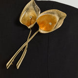 Carolina Herrera strapless dress with calla lily brooch