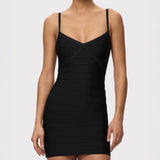 Black bandage dress worn by a model on a white background
